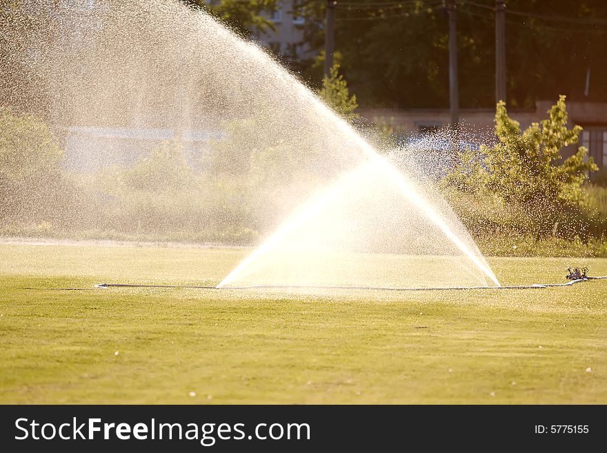 Fire hose badly leaking, outdoors. Fire hose badly leaking, outdoors