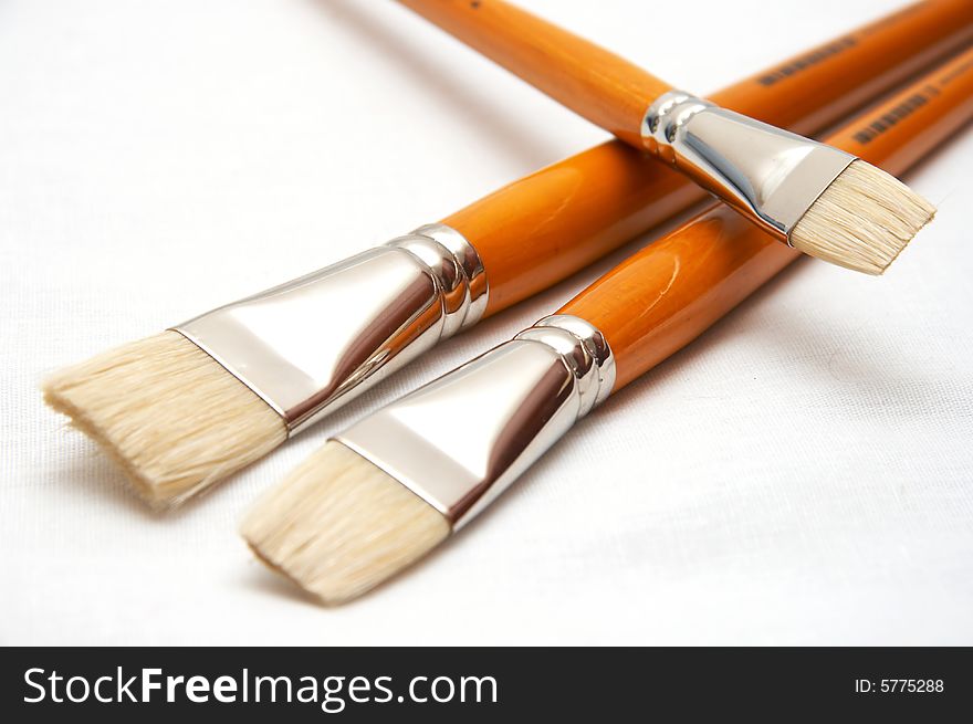 Three yellow brushes for drawing on white background (isolated)