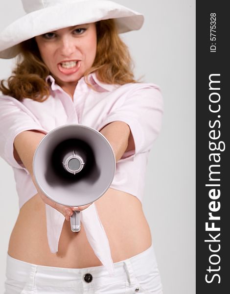 Beautiful young girl with megaphone dressed white. Beautiful young girl with megaphone dressed white