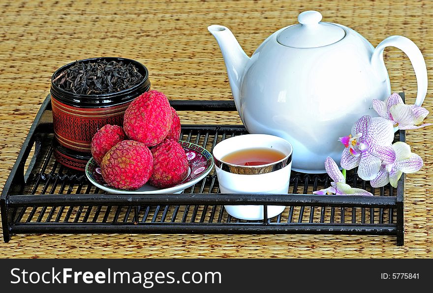 Asian pottery tea  set with chinese tea and litchees. Asian pottery tea  set with chinese tea and litchees