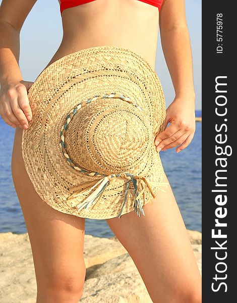 Pretty girl with panama hat on the beach.