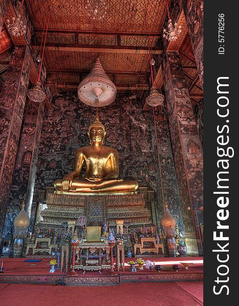 This is a HDR capture of the 8 meter high Buddha Shakyamuni at Wat Suthat in Bangkok.