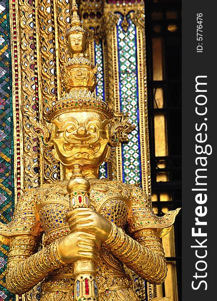 Thailand Bangkok; the wat Phra Kaew shelter the most sacred image of Thailand the Emerald Buddha. The temple is situated in the northeast corner of the Grand Palace. View of a guardian statue or yakshas. Thailand Bangkok; the wat Phra Kaew shelter the most sacred image of Thailand the Emerald Buddha. The temple is situated in the northeast corner of the Grand Palace. View of a guardian statue or yakshas