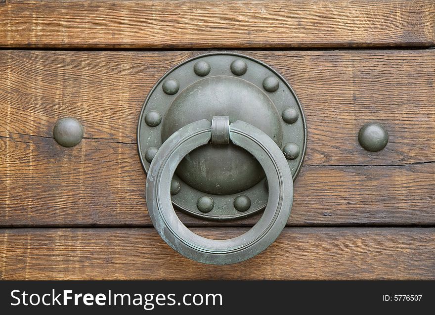 Small door handle made of brass on a church door