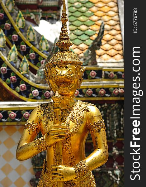Thailand Bangkok; the wat Phra Kaew shelter the most sacred image of Thailand the Emerald Buddha. The temple is situated in the northeast corner of the Grand Palace. View of a golden statue. Thailand Bangkok; the wat Phra Kaew shelter the most sacred image of Thailand the Emerald Buddha. The temple is situated in the northeast corner of the Grand Palace. View of a golden statue