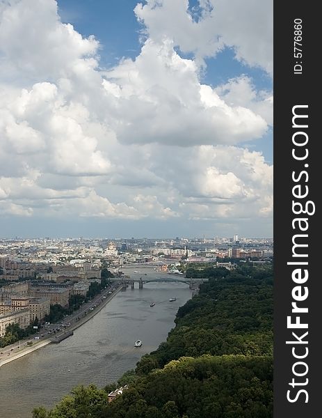 City and white clouds in a blue sky. City and white clouds in a blue sky