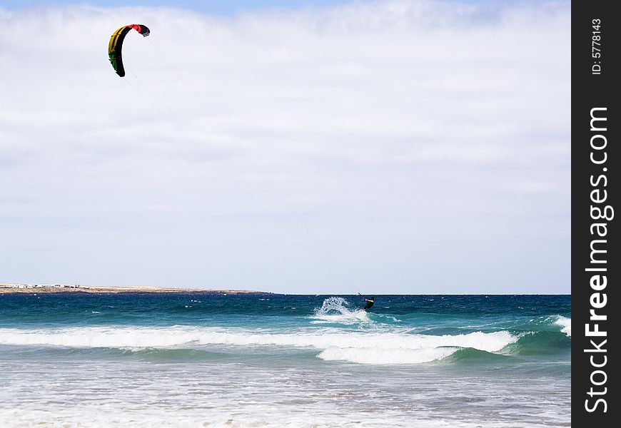 Kite-surfer on the waves at lanzarote. Kite-surfer on the waves at lanzarote