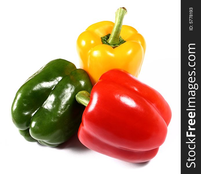 Red, yellow and green paprika on white background