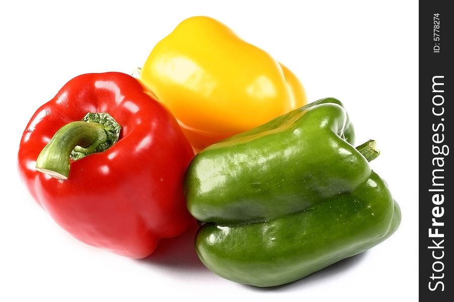 Red, yellow and green paprika on white background