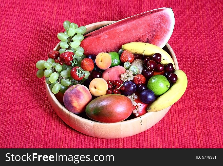 Fresh fruit on red background