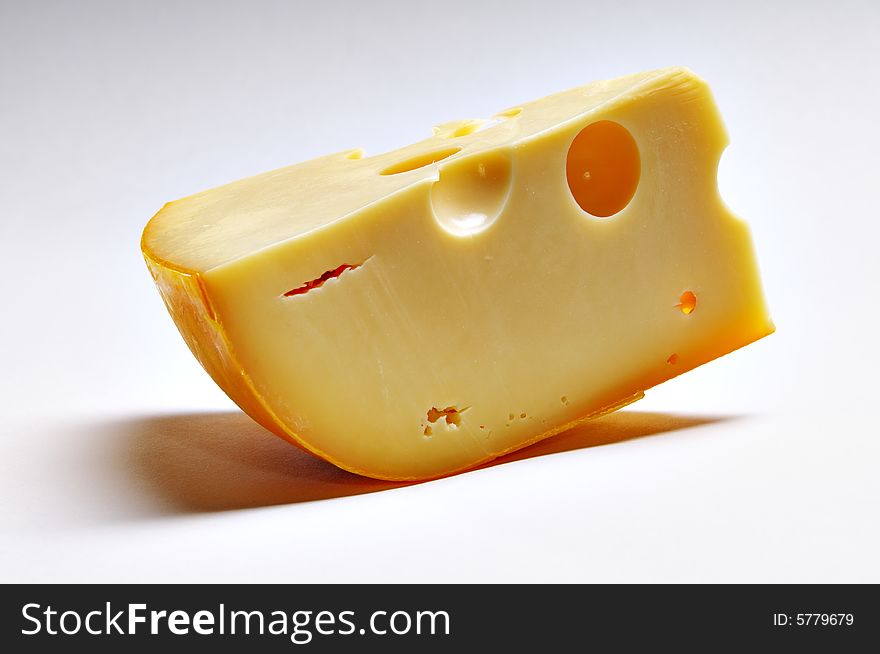 Big piece of cheese on the white background. Big piece of cheese on the white background.
