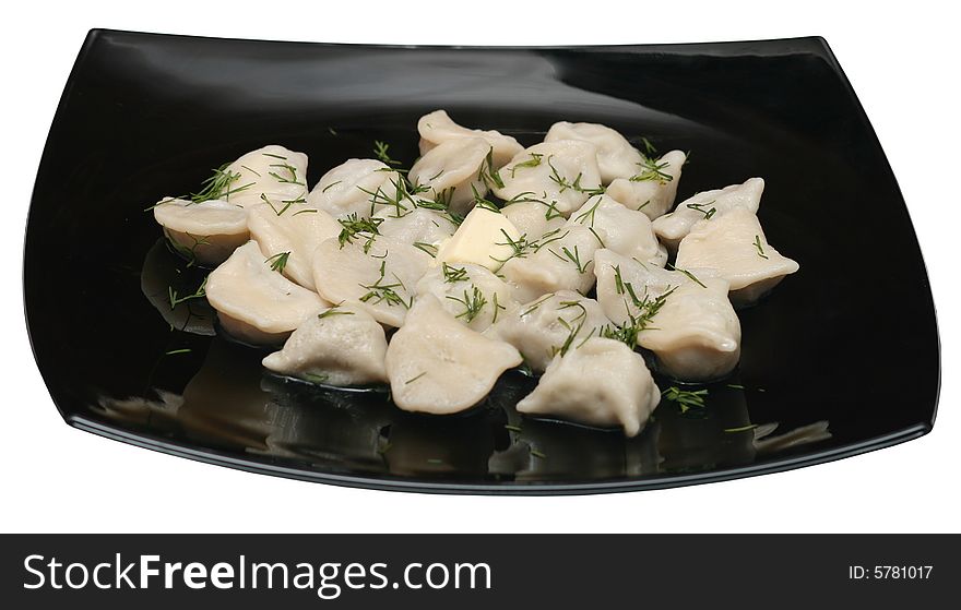 Dumplings with butter and dill on the black plate