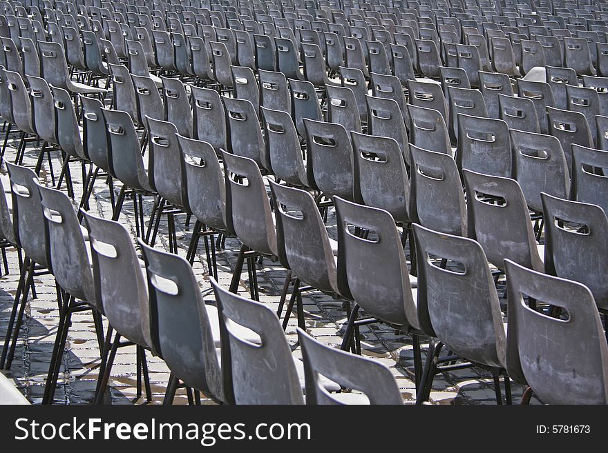 Rows of empty grey chairs