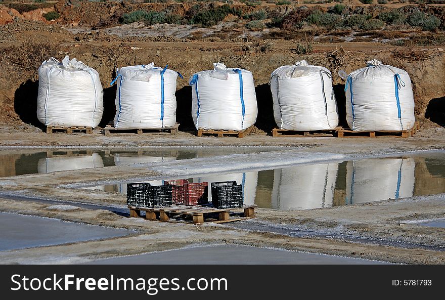 Five bags full of marine salt properly ordered, on the saline near OlhÃ£o, Portugal. Five bags full of marine salt properly ordered, on the saline near OlhÃ£o, Portugal.