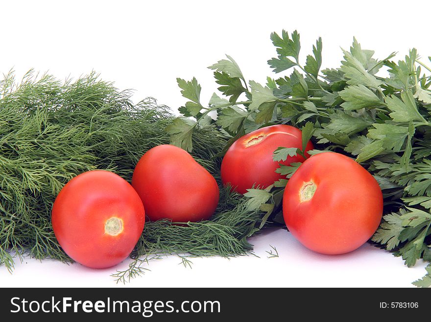 Four tomatos between dill  and parsley isolated on white background food and vegetables. Four tomatos between dill  and parsley isolated on white background food and vegetables
