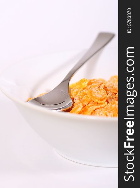 Shot of tasty cornflakes with a spoon. Small depth of field gives a nice look. Shot of tasty cornflakes with a spoon. Small depth of field gives a nice look.