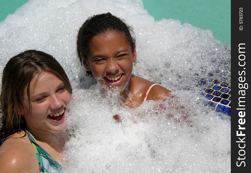 A picture of two tween girls who are best friends in a jacuzzi in lots of bubbles. A picture of two tween girls who are best friends in a jacuzzi in lots of bubbles.