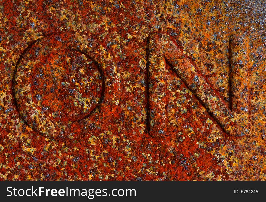 Macro image of an on sign covered in rust. Macro image of an on sign covered in rust
