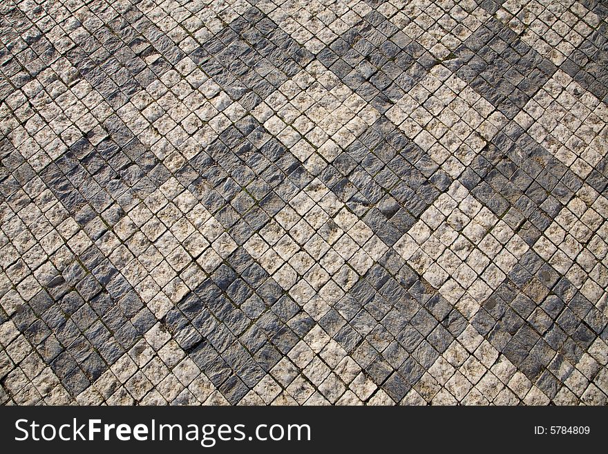 Stone design in Prague sidewalk. Background texture.