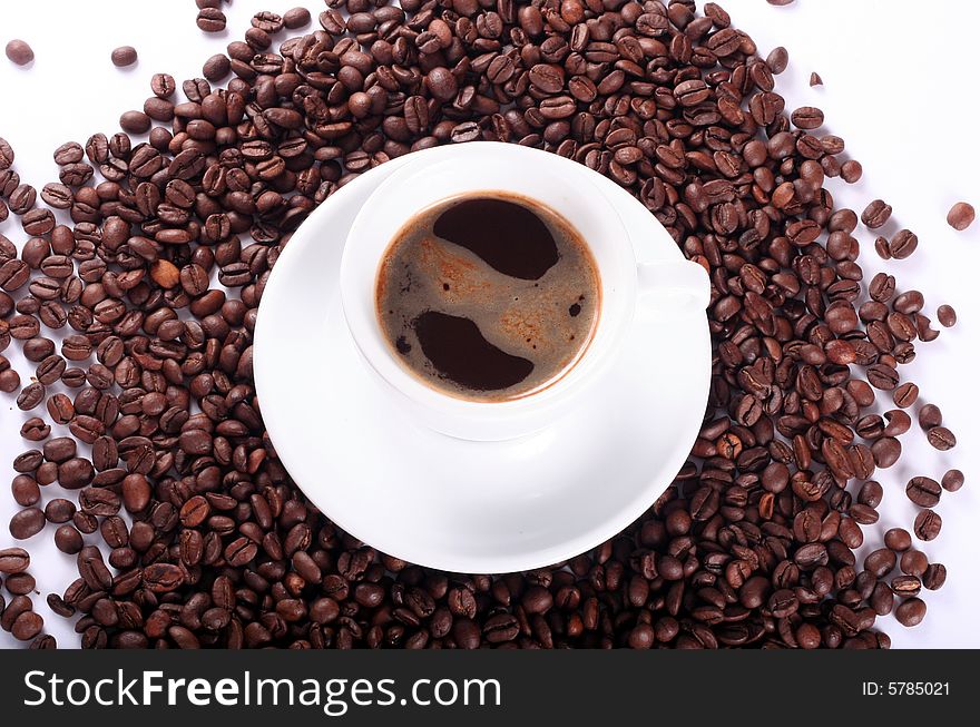 Coffee and coffee beans in white cup isolated. Coffee and coffee beans in white cup isolated