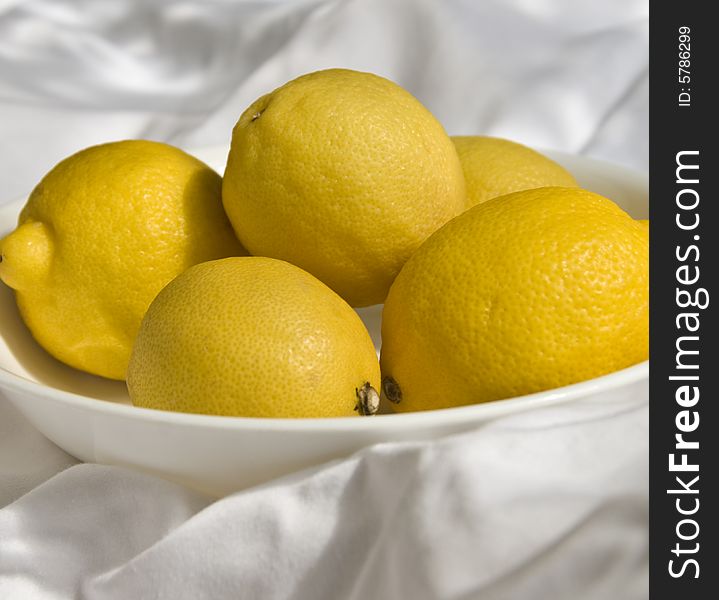 A bowl of bright yellow lemons. A bowl of bright yellow lemons.