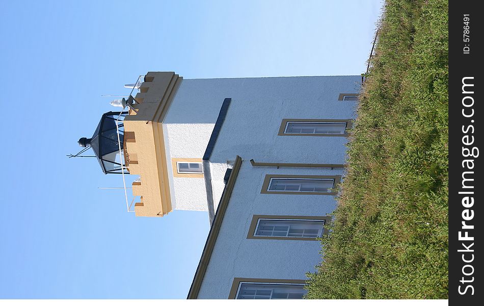 Looking up at a lighthouse with a square tower. Looking up at a lighthouse with a square tower.