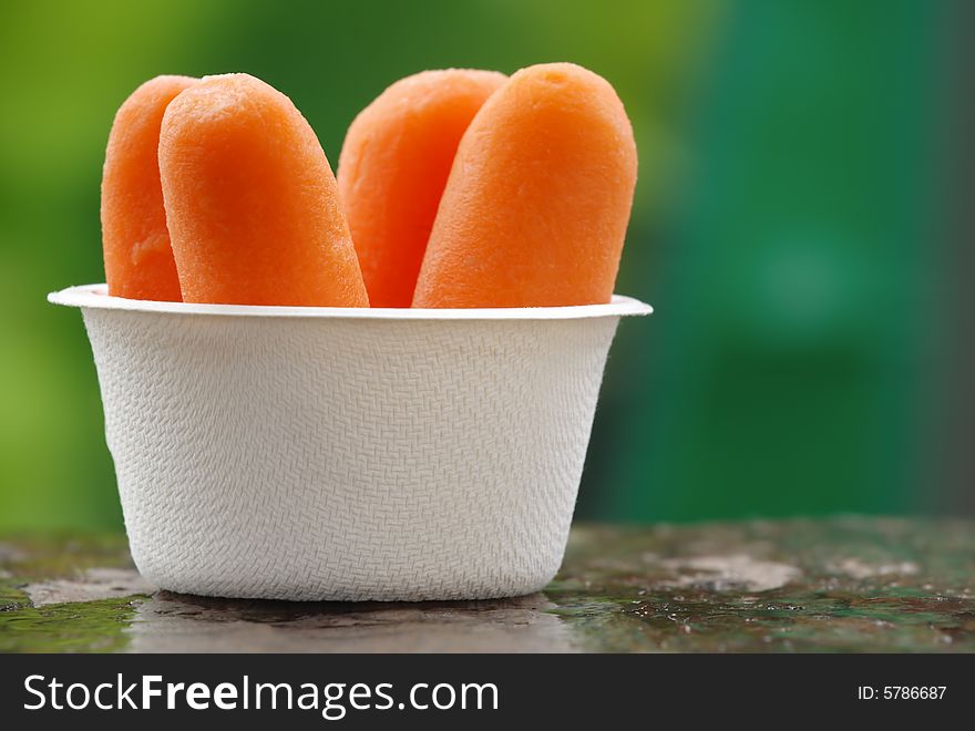Organic peeled carrots in a recyclable bowl.