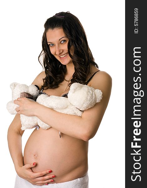 Pregnant woman holding her belly and toys