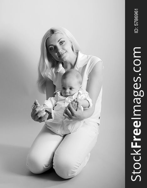 Black and white portrait of happy mother with baby