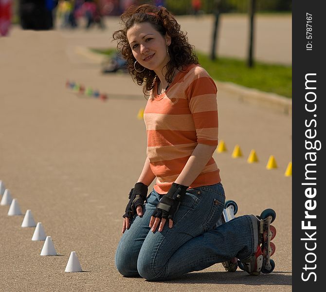 Smiling Rollerskating Girl Outdoors on Asphalt Background