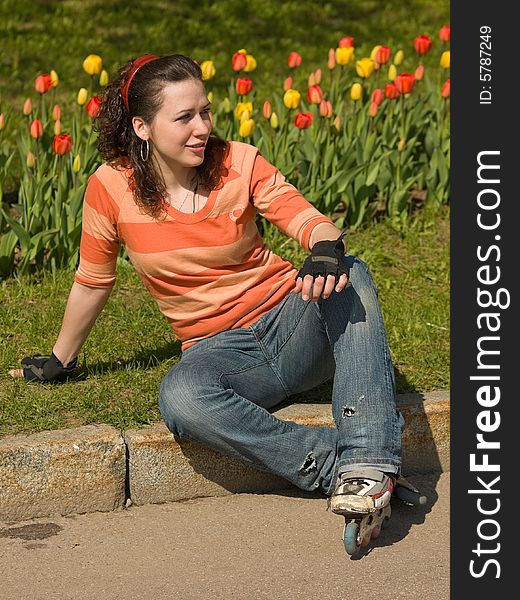 Smiling Rollerskating Girl with Flowers on Background