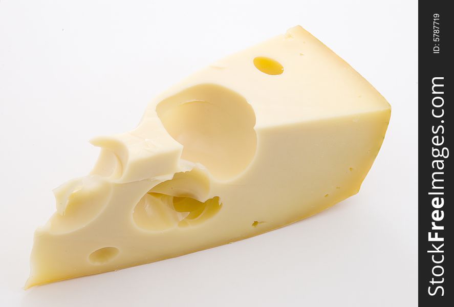 Triangular piece of cheese with greater holes