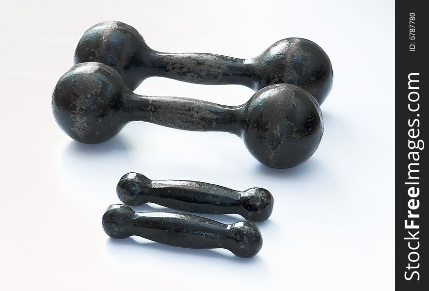 Greater and small black dumbbells isolated. Greater and small black dumbbells isolated