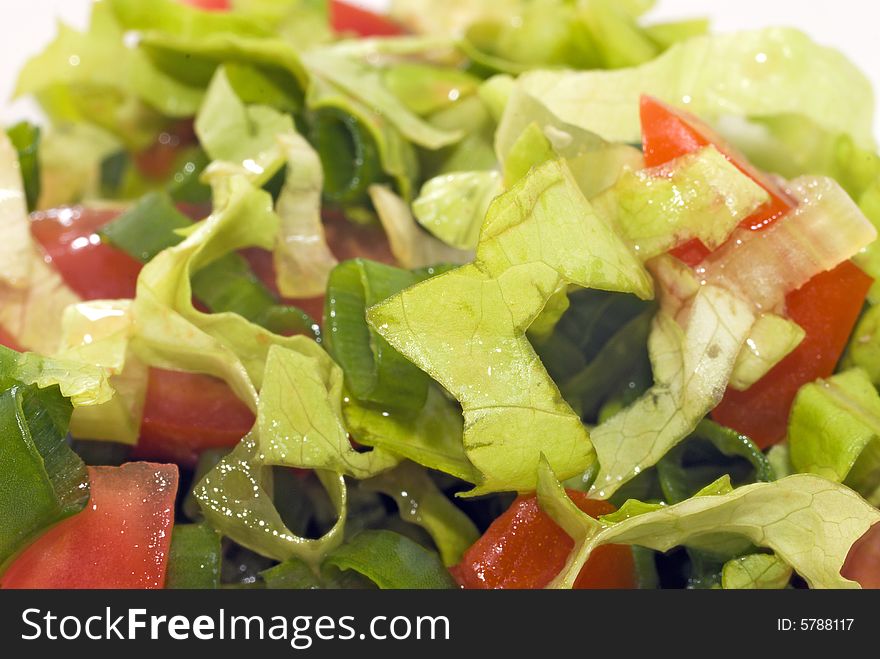 Slices of salad, tomatoes, green onions close-up. Slices of salad, tomatoes, green onions close-up