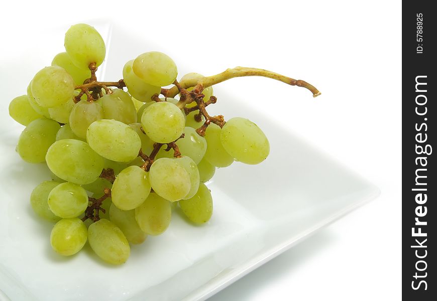 Fresh bunch of green grapes in white bowl and isolated on white background. Fresh bunch of green grapes in white bowl and isolated on white background