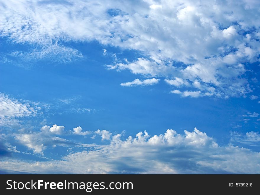 The sky is filled with bright clouds in the late afternoon with a path of clear blue. The sky is filled with bright clouds in the late afternoon with a path of clear blue