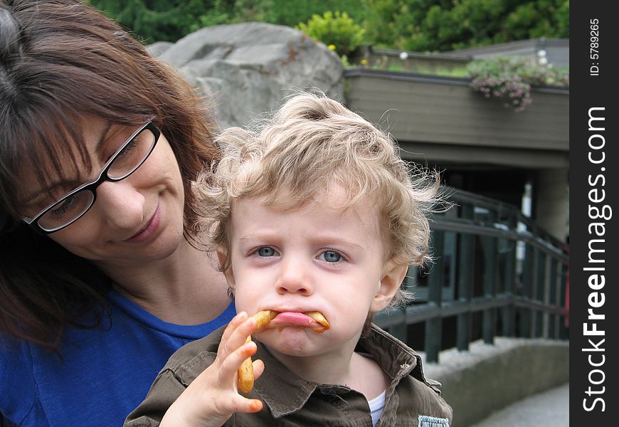 Mother and son eating french fries