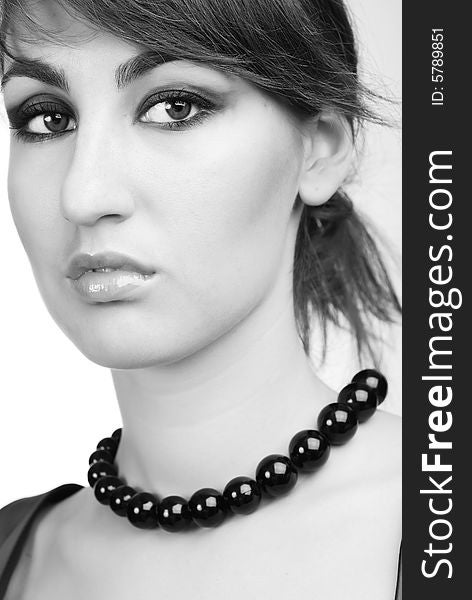 Portrait of young girl with black beads on her neck