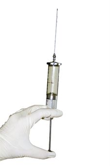 Gloved Hand With A Syringe Royalty Free Stock Images