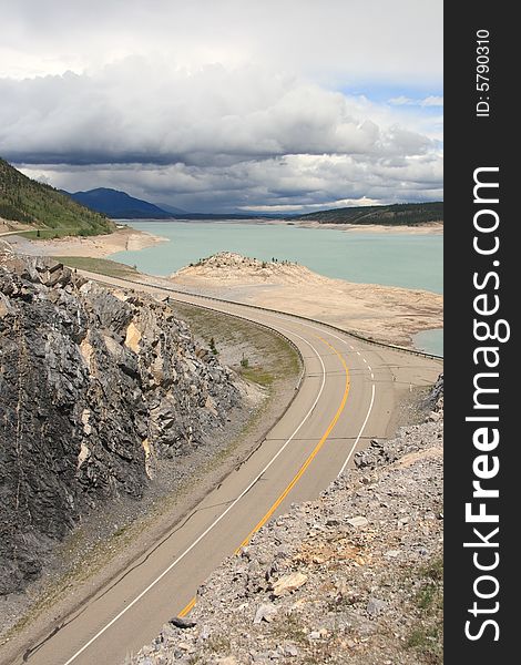 A highway winding along a mountain lake in the Canadian Rockies. A highway winding along a mountain lake in the Canadian Rockies