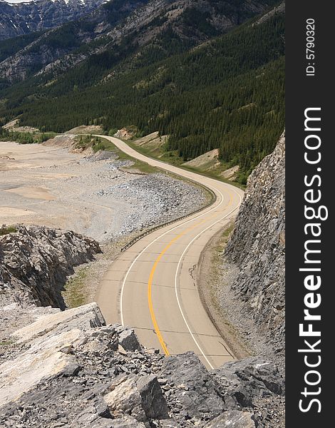 A serpentine road stretching along a mountainside in the Canadian Rockies. A serpentine road stretching along a mountainside in the Canadian Rockies