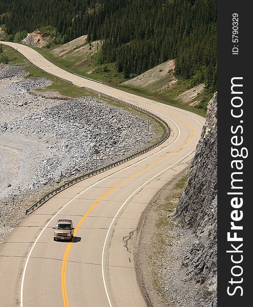 A serpentine road stretching along a mountainside in the Canadian Rockies. A serpentine road stretching along a mountainside in the Canadian Rockies