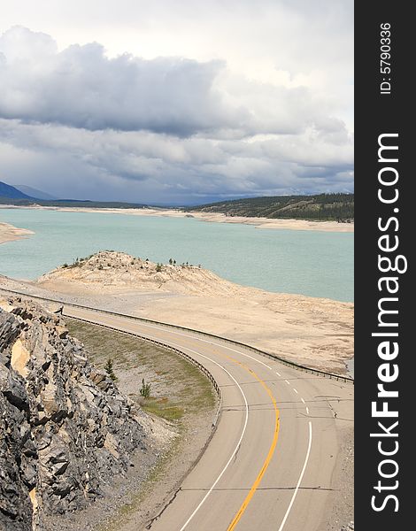 A highway winding along a mountain lake in the Canadian Rockies. A highway winding along a mountain lake in the Canadian Rockies