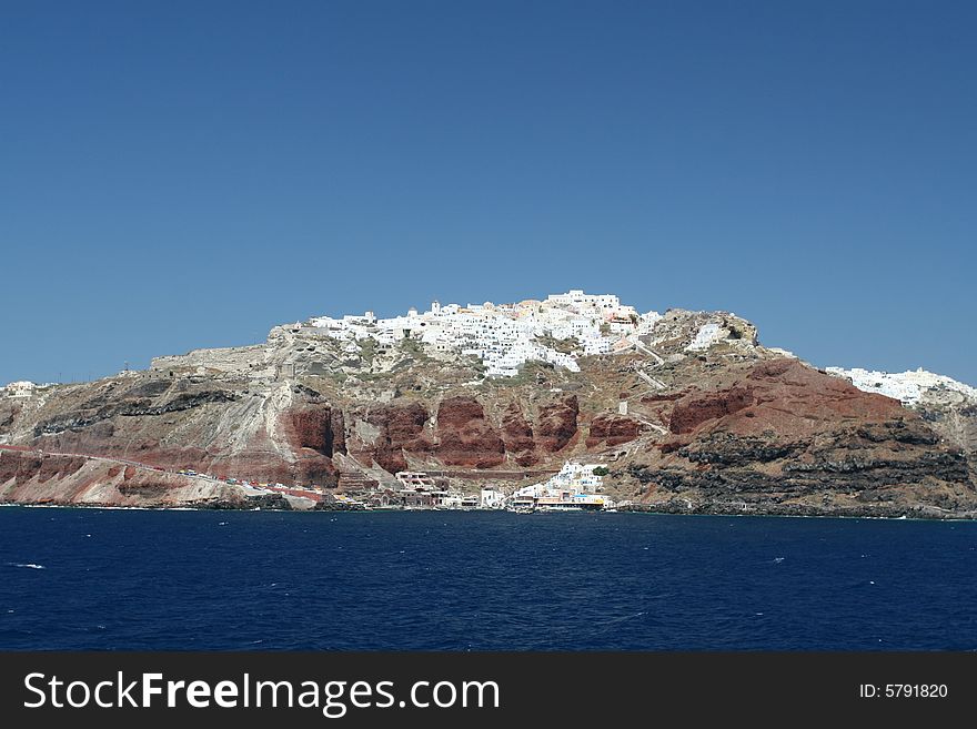 Vibrant coastal town perched on volcanic rock in Greece. Vibrant coastal town perched on volcanic rock in Greece.