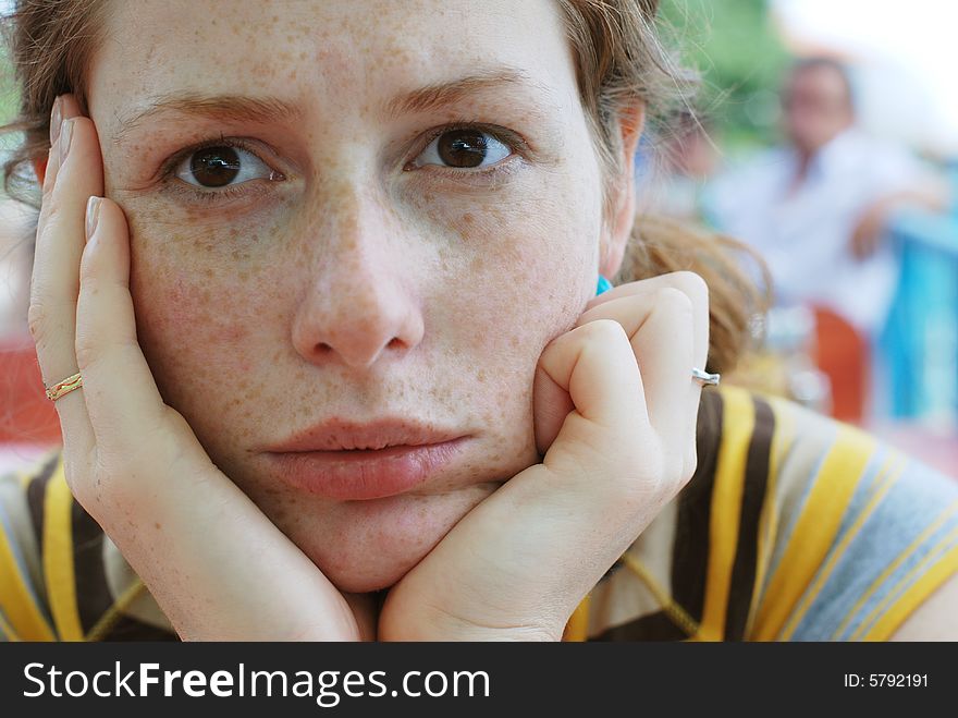 Girl sitting in a cafe and wondering or thinking. Girl sitting in a cafe and wondering or thinking