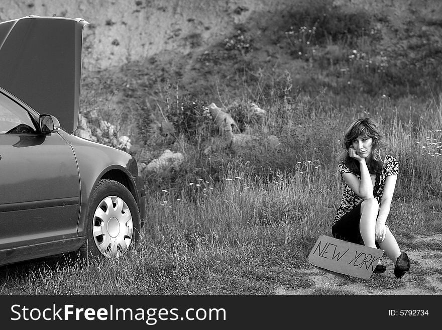 A sexy girl trying to repair the car