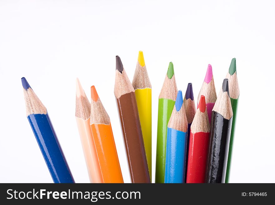 Colored crayons on white background