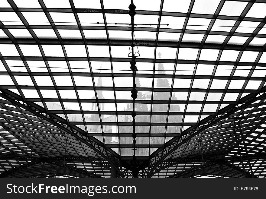 Cologne cathedral through transparent roof of railway station black and white