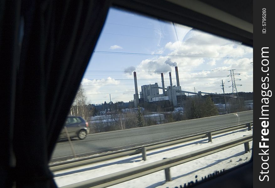 Chimney of a factory out of the window. Chimney of a factory out of the window.