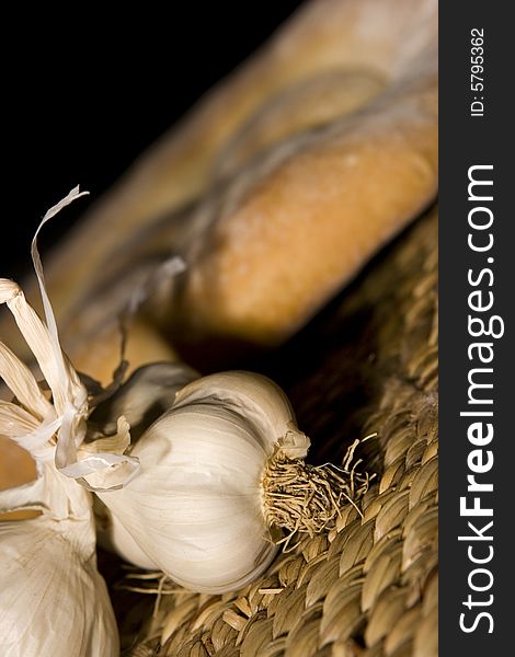 Garlic, made in the studio; healty medicine; bread in the background. Garlic, made in the studio; healty medicine; bread in the background